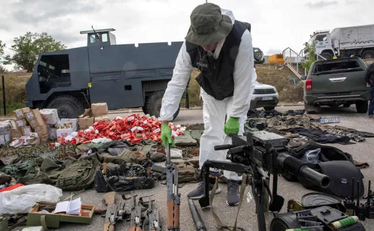 Kosovo police officers display seized weapons and military equipment during the police operation in the village of Banjska in a police camp in Mitrovica, Kosovo on September 25, 2023 [Visar Kryeziu/AP]